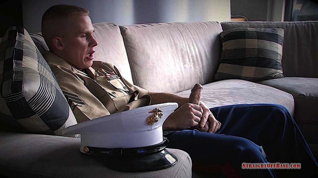 uniformed straight marine sitting on a couch with his hard cock in his hand masturbating to porn
